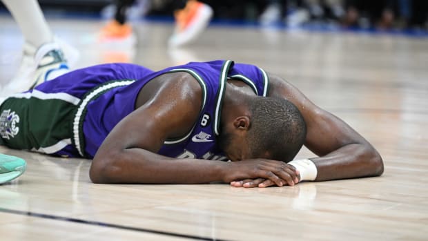 Mar 30, 2023; Milwaukee, Wisconsin, USA; Milwaukee Bucks forward Khris Middleton (22) goes down after a collision with a Boston Celtics player in the second half causing him to sit out the rest of the game at Fiserv Forum.